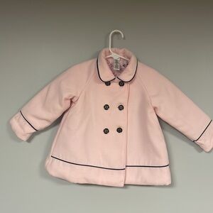 Adorable Little Me pea coat. The coat is light pink with navy trim, 2T